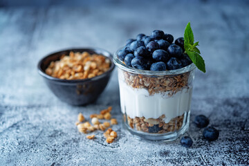 Blueberry Greek yogurt granola parfait in a glass