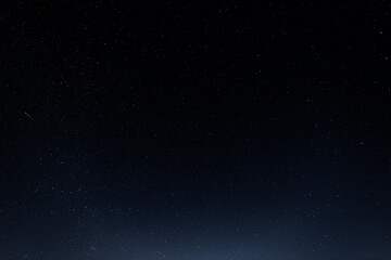 A starry sky with many stars and a flying meteor
