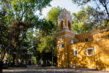 Old Mexican Church surrounded by trees in Coyoacan
