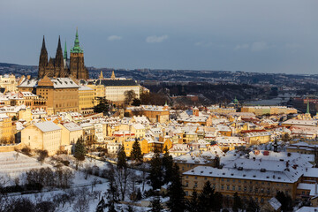 Snowy Prague City with gothic Castle from Hill Petrin in the sunny Day, Czech republic