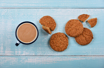 Oatmeal cookies and pannikin of hot chocolate