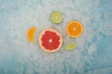 Fresh citrus fruit slices over crushed ice