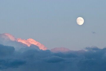 Background image of the white moon with fluffy clouds at the bottom.