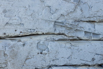 Background image of horizontal cracks in a stone wall.