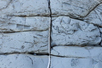 Background image of a stone wall with cracks.