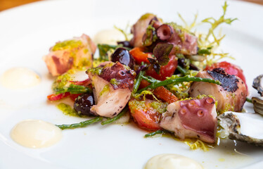 Grilled seafood warm salad on white plate