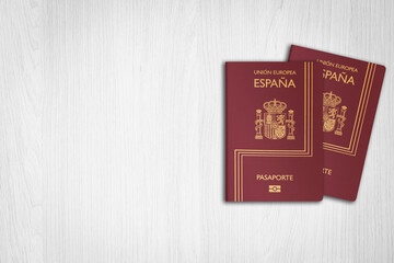 Two Spanish passports, on a white wooden background, travel style