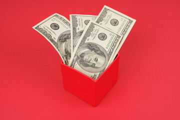 On a red background, money is in a red box.