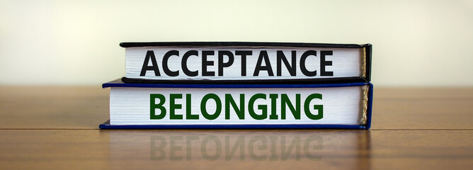 Acceptance and belonging symbol. Books with words 'acceptance and belonging' on beautiful wooden table, white background. Business, acceptance and belonging concept. Copy space.
