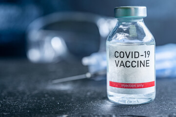 A single bottle vial of Covid-19 vaccine. Medical concept vaccination hypodermic injection...