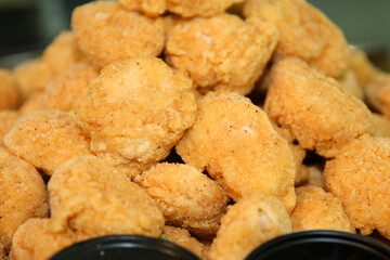 Close-up shot of piled up fried chicken nuggets 