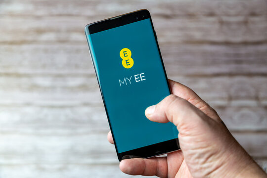 02-05-2021 Portsmouth, Hampshire, UK A Mobile phone or cell phone being held showing the EE Mobile app open on screen