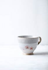 Traditional, handcrafted ceramic on bright wooden background. Copy space.	