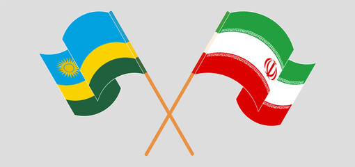 Crossed and waving flags of Rwanda and Iran