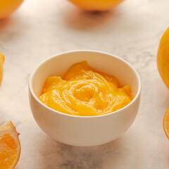Homemade fresh pudding or tangy lemon curd in a white bowl.Selective focus
