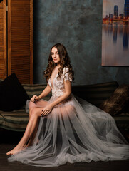Fototapeta premium Portrait of beautiful young female in white underwear. Seductive woman in white linen and peignoir.