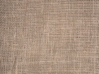 Fragment of a rough beige fleecy burlap.