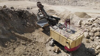 Heavy equipment loads limestone into the machine