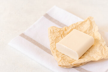 Wooden soap dish, craft paper, cotton fabric, soap, over white background. Zero waste, natural organic bathroom tools. Plastic free life. Ecological skin care, body treatment concept