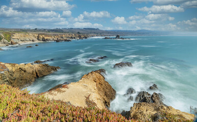 Beautiful seascape of the Pacific coast in California, waves, rocks, sky, sun. Concept, perfect postcard and guide.