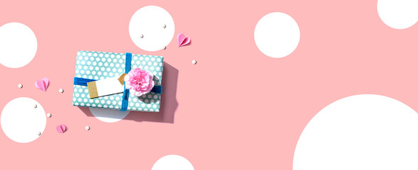 Appreciation theme with a gift box and a pink carnation flower