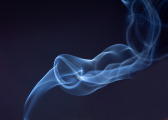 Fototapeta premium blue jet wave of smoke isolated on black background