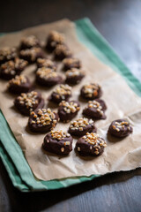 Dried apricots in chocolate sprinkled with nuts.