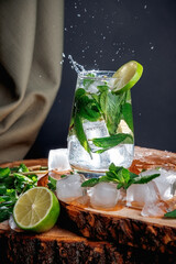 Mojito cocktail on a wooden stand. mint, ice, and white rum.