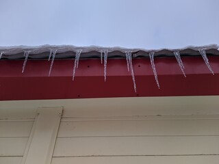 icicles hang from the roof of the building