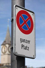 official no stopping sign in front of a church. german text translation: no stopping, whole place