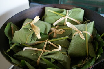 Homemade tamales wrapped in banana leaves