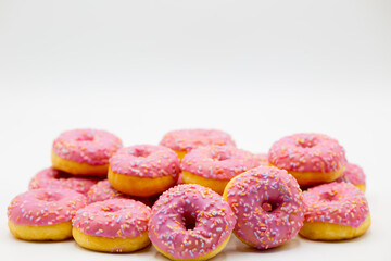 Group of pink donuts on a white background with copy space above