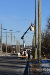 Lift truck with electrician repairing street light