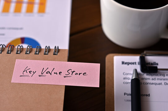 There's a clipboard, a cup of coffee and a notebook with a sticky note stuck to it that says KVS.