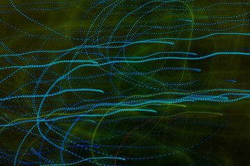 Light painting neon green and blue as an abstract background with low exposure.
