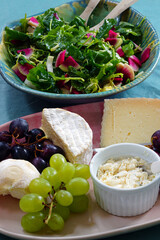 View of a cheese platter with fresh grapes