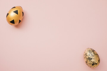 Easter golden decorated eggs on pastel pink background. Minimal easter concept. Happy Easter card with copy space for text. Top view, flatlay