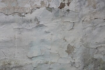 Obraz na płótnie Canvas gray white texture of shabby plaster with cracks on an old concrete wall