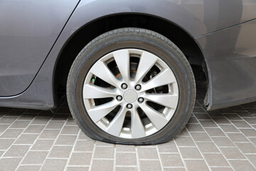 Car flat tire on tiled floor