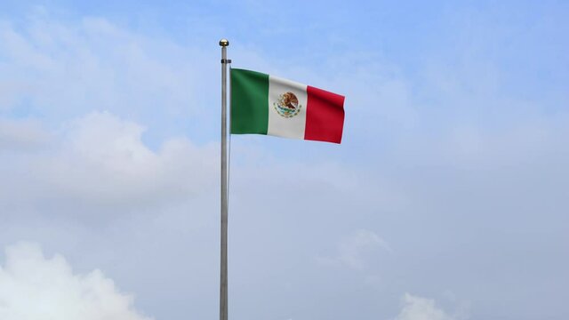 Mexican flag waving in the wind with blue sky and clouds. Mexico banner blowing, soft and smooth silk. Cloth fabric texture ensign background. Use it for national day and country occasions concept-Dan