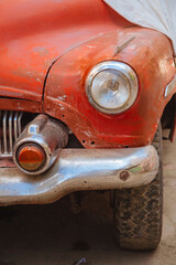 old rusty car. Close up of a red vintage car. 