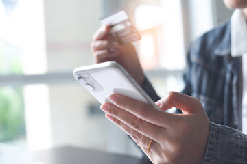 Mobile banking, Online shopping, digital banking, internet payment concept. Woman hand using mobile smart phone payments and credit card for online shopping