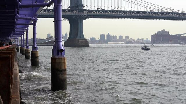 Boat passing under Manhattan Bridge, East River in New York City Manhattan in 4K