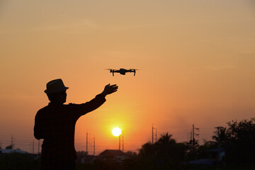 Fototapeta na wymiar drone pilotage at sunset Close up of quadrocopter outdoors