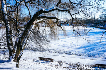 Frozen lake covered with snow in winter
