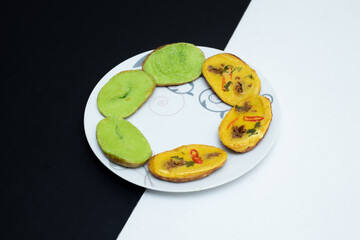 Traditional Malaysian food. Asian culinary isolated on black and white background. Made from flour, salt and palm sugar.