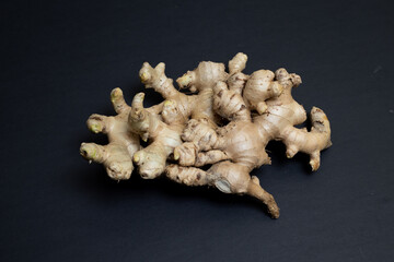 Fresh organic ginger isolated on black background. It is widely used as a spice and a folk medicine