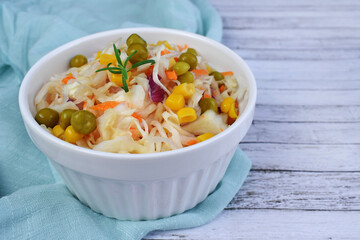 Salad of fresh cabbage with green peas and corn.