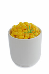 Canned corn in a white dish on a white background.