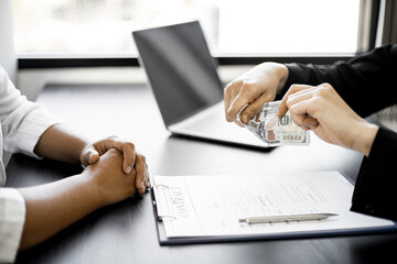 Business women tearing dollars in front of business partners, business women refusing to accept...